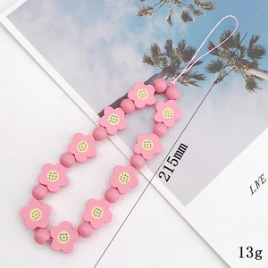Pink wooden flower phone strap with round beads and summer vacation style background