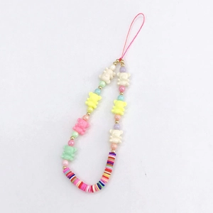 Close-up of colorful handmade phone charm featuring resin bears and vibrant assorted beads