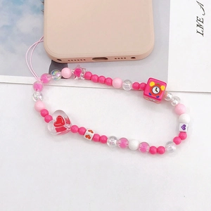 Pink and white beaded phone charm strap with a large transparent acrylic heart pendant