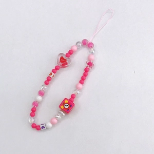 Detail view of handmade pink acrylic heart phone charm strap with beaded stars