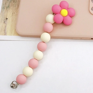Close-up of pink floral charm and matte beads on a sweet macaron style phone lanyard