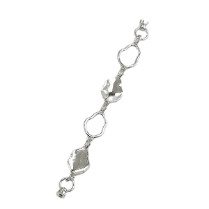 Minimalist silver fluid lava metal bracelet with irregular geometric links on white background
