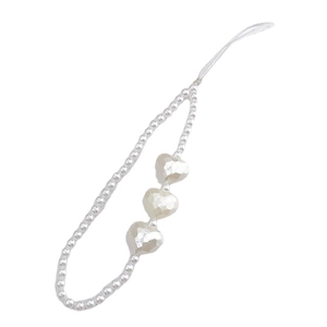 White pearl bead phone charm strap featuring three dimensional heart shaped accents