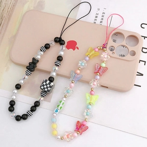 Beaded phone charms featuring black bear checkered blocks and colorful butterflies