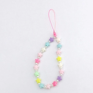Detail view of colorful star-shaped beaded phone charm with pastel resin stars