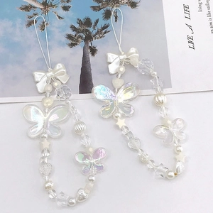 Two iridescent beaded phone charms with butterfly, heart, and star shapes for women
