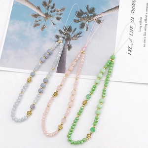 Three colorful beaded crystal phone lanyards in pink, green and grey with gold accents