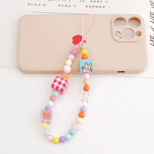 Detail of colorful beaded phone strap with cute rabbit blocks and plaid cube charm