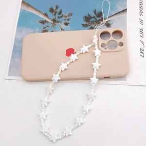 Handmade white star beaded phone charm strap with clear micro beads on a phone case