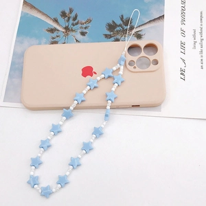 Detail of blue star-shaped resin beads and white round pearls on a handmade phone lanyard