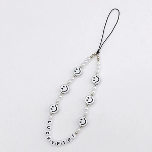 Detail of beaded phone strap featuring white pearls, smiley faces, and LUCKYPIPI letter beads
