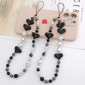 Beaded heart phone charm featuring black and white striped beads on a pink phone case