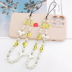 Detail of beaded phone strap with acrylic smiley faces, white pearls and heart charms