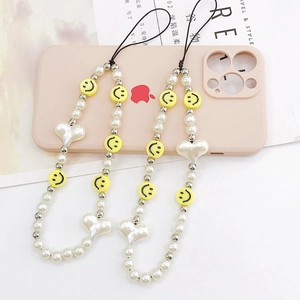 Handmade beaded phone charms with yellow smiley faces, white pearls, and heart pendants
