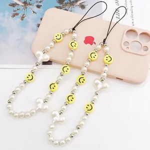 Beaded phone charms with smiley faces, pearls, and heart beads in a stylish 2-piece set