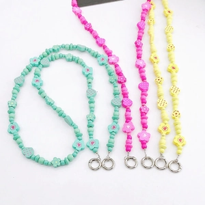 Floral wooden bead phone charms in mint green, pink, and yellow with heart and strawberry shapes