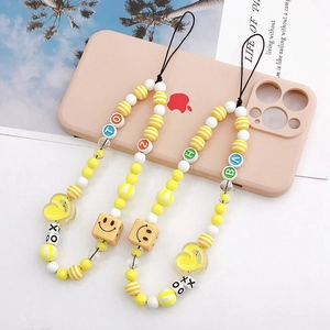Three-piece set of yellow beaded phone charms with letters, hearts, and smiley faces