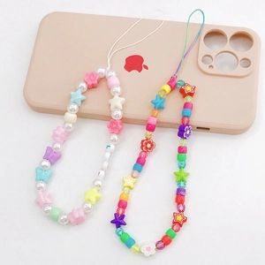 Close-up of colorful handmade beaded phone lanyards with star and butterfly charms