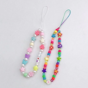 Detail of colorful polymer clay phone straps with LOVE letter beads and butterfly charms