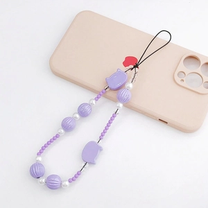 Detailed close-up of purple beaded phone strap with cat head beads and pearls