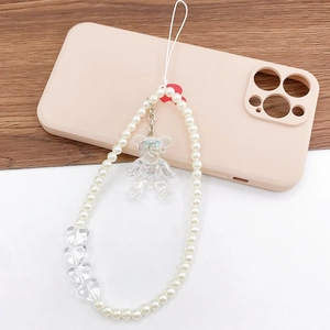Charming pearl phone strap with laser teddy bear and heart charms on a pink case