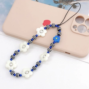 Handmade floral beaded phone strap with white and blue flowers on a pink case