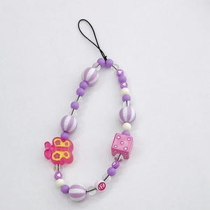Acrylic butterfly beaded phone lanyard with purple and pink charms on white background