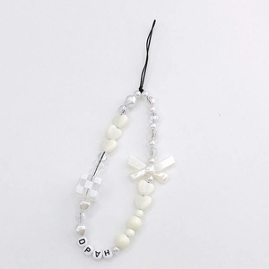 Detail of white beaded phone strap with pearl bow and checkerboard heart charms