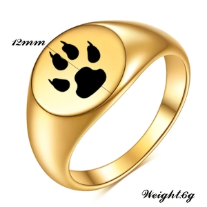 Detailed view of 12mm gold signet ring with black laser-engraved pet paw print motif