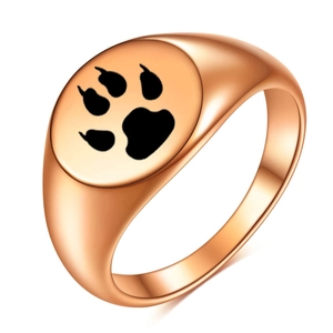 Macro detail of rose gold signet ring with a laser engraved black animal paw print