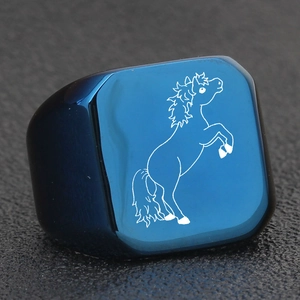 Macro shot of blue signet ring with white laser engraved horse and brushed texture