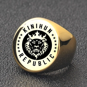 Macro shot of gold lion king signet ring featuring Kinihun Republic crown engraving