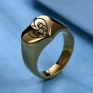 Detail of gold heart signet ring featuring laser engraved family family figures