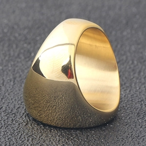 Macro view of wide gold dome ring featuring high-polish finish and brushed interior metal