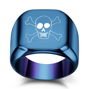 Detailed macro view of punk style signet ring featuring blue purple gradient and skull