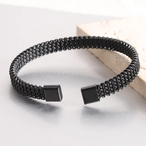 Macro detail of black mesh woven stainless steel open cuff bracelet with square ends