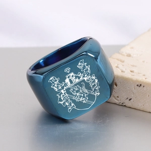Close-up of blue stainless steel signet ring with laser engraved lion crest and crown