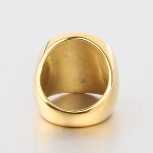 Detail of wide gold ring showing polished exterior and brushed metal texture finish