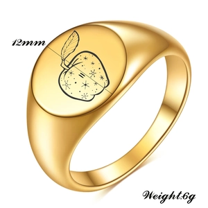 Detail of 12mm gold stainless steel ring with laser apple and star engraving
