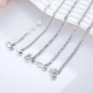 Set of five stainless steel charm bracelets featuring pearls and heart pendants
