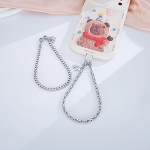 Stainless steel phone charm with pearls and heart pendant on a bear-patterned phone case