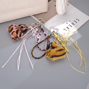 Plush leopard print heart bag charms with silk ribbon and beaded chain decorations