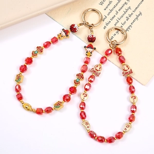Beaded red crystal phone charm with gold Fortune pendants and Chinese lucky symbols