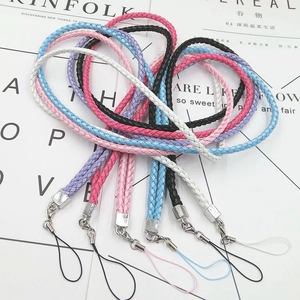 Close-up of colorful braided lanyards with silver metal clasps on a stylish magazine