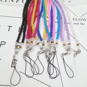 Macro shot of colorful beaded crystal lanyards with metal lobster clasps and phone rings