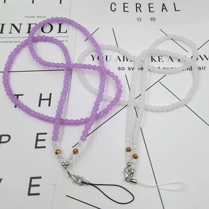 Detail of beaded crystal phone lanyards in purple and white with metal lobster clasps