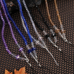 Detail view of crystal beaded phone lanyards in purple, blue, and champagne gold hues