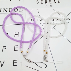 Detail view of crystal beaded phone lanyards with lobster clasps in purple and white colors