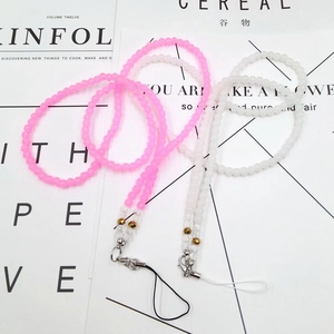 Detailed view of pink and ivory beaded crystal phone lanyards with golden lobster clasps
