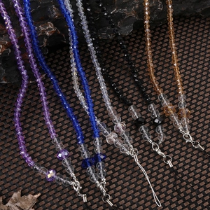 Macro detail of faceted crystal bead phone lanyards with silver metal lobster clasps